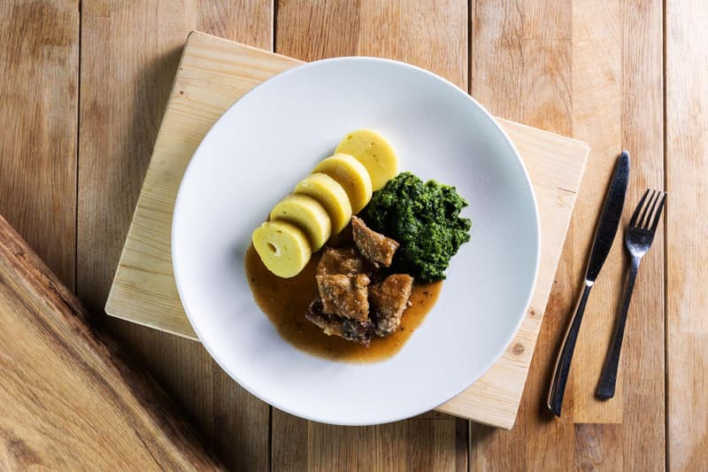 Roast pork with potato dumplings and spinach by Jan Bures